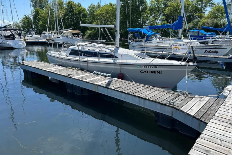Slide: The Image of 1989 O'Day 272 sailboat docked at marina, surrounded by other boats. - 2