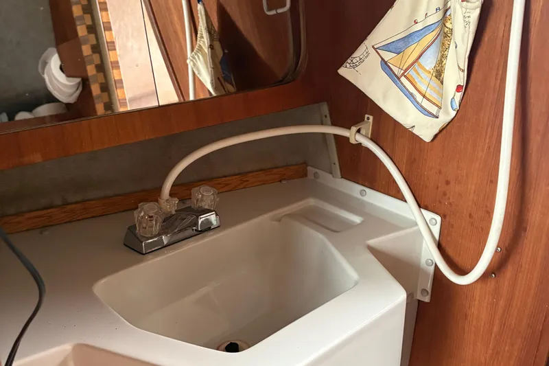 Slide: The Image of Interior sink area of a 1989 O'Day 272 sailboat with nautical decor. - 20