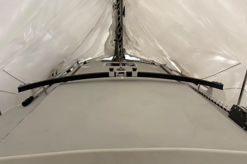 Slide: The Image of 1989 O'Day 272 sailboat under protective cover, showcasing deck and rigging. - 3