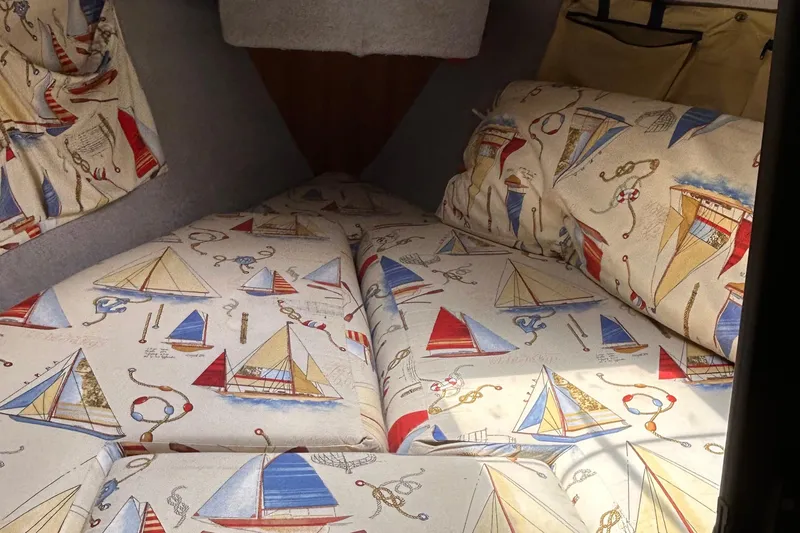 Slide: The Image of Interior of 1989 O'Day 272 sailboat with nautical-themed upholstery. - 9