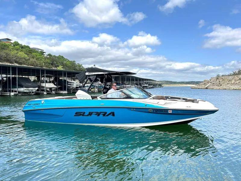 Slide: The Image of 2017 Supra SE 550 boat on a lake with a scenic background. - 16