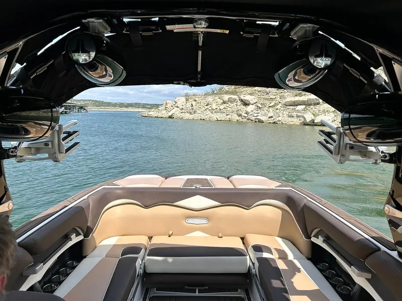 Slide: The Image of 2017 Supra SE 550 boat interior with lake view and rocky shoreline. - 26