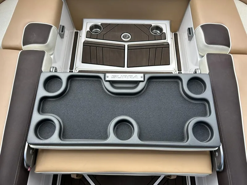 Slide: The Image of 2017 Supra SE 550 boat interior with cup holders and cushioned seating. - 30