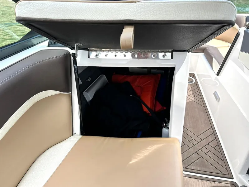Slide: The Image of 2017 Supra SE 550 boat interior storage compartment with open seat lid. - 34
