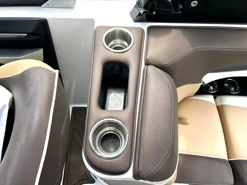 Slide: The Image of 2017 Supra SE 550 boat interior with cup holders and brown seating. - 38