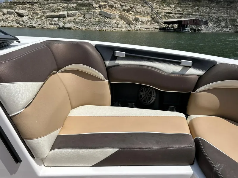 Slide: The Image of Luxurious seating on a 2017 Supra SE 550 boat, with scenic lake backdrop. - 48