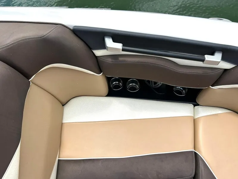 Slide: The Image of 2017 Supra SE 550 boat interior with brown and beige seating. - 49