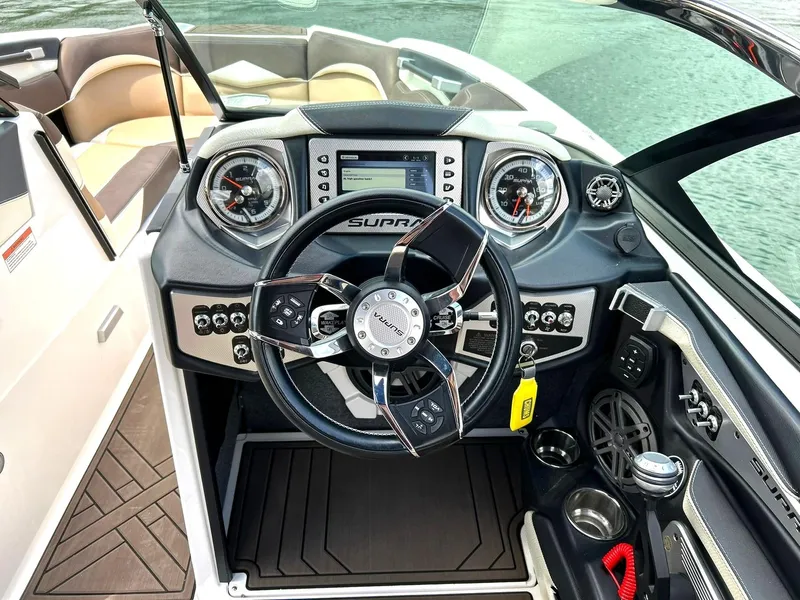 Slide: The Image of 2017 Supra SE 550 boat dashboard with steering wheel and control panel. - 5