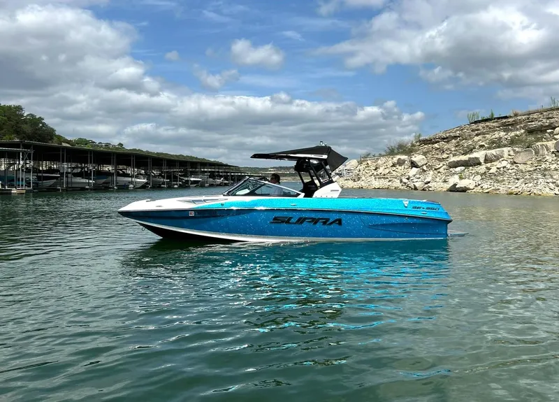 Slide: The Image of 2017 Supra SE 550 boat on a lake under a partly cloudy sky. - 7