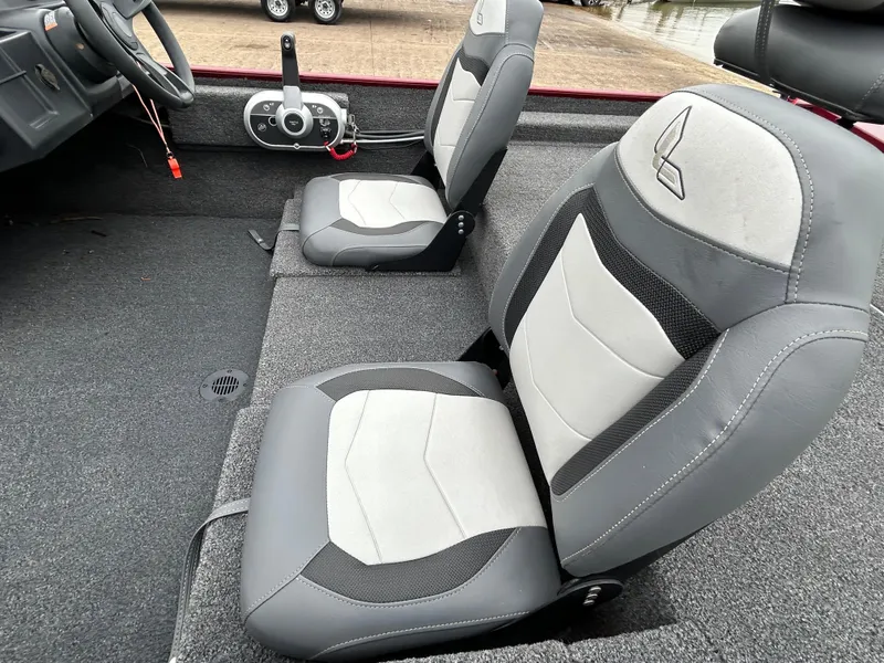 Slide: The Image of 2022 Lowe Skorpion 17 boat interior with gray and white seats, steering wheel, and controls. - 25