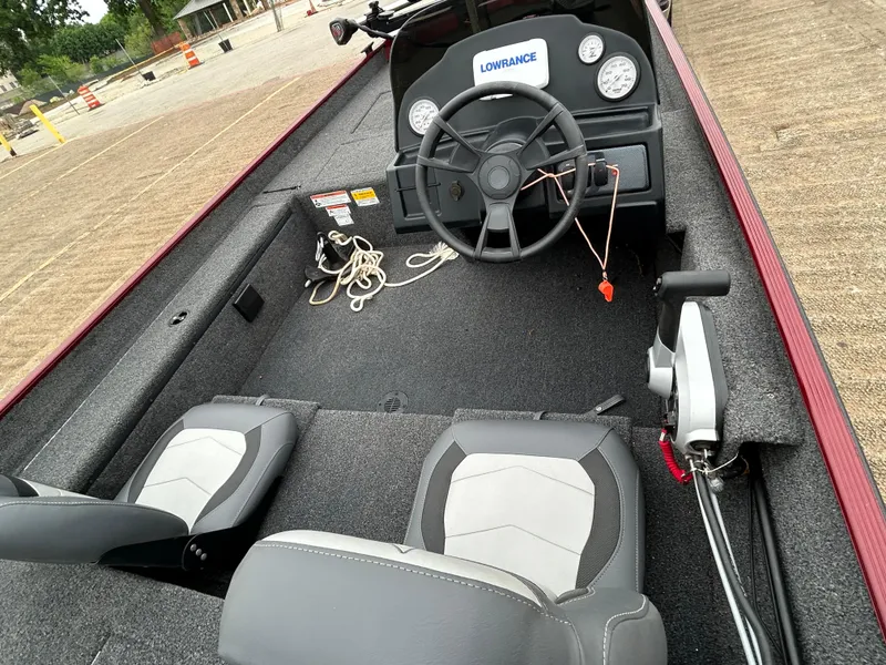 Slide: The Image of 2022 Lowe Skorpion 17 boat interior with steering wheel and seating. - 26