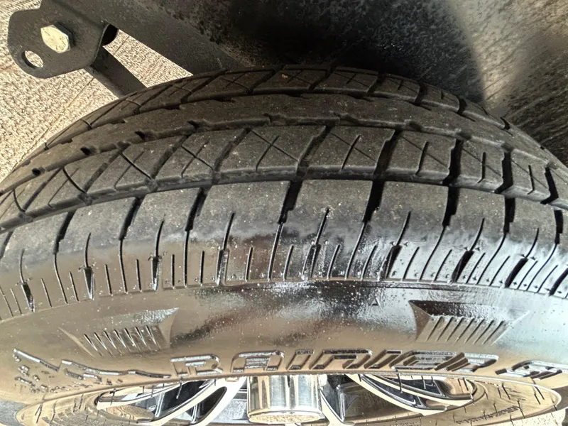 Slide: The Image of Close-up of a 2022 Lowe Skorpion 17 tire with detailed tread pattern. - 34