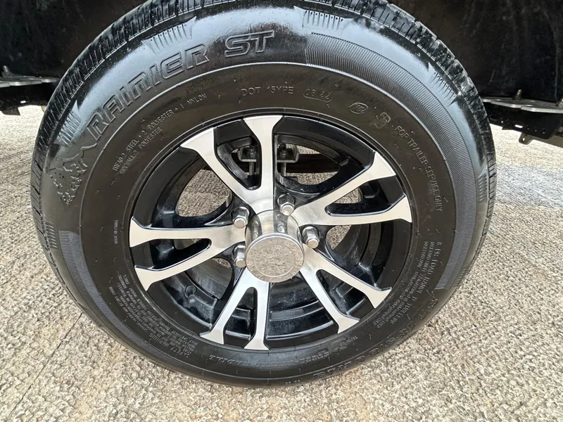 Slide: The Image of Close-up of 2022 Lowe Skorpion 17 tire and alloy wheel on pavement. - 35