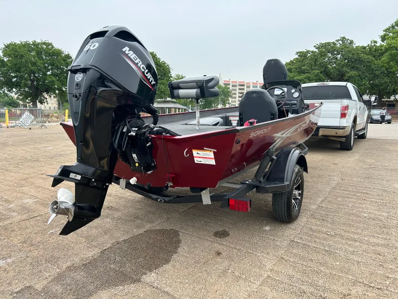 Slide: The Image of 2022 Lowe Skorpion 17 boat with Mercury engine on a trailer in a parking lot. - 5