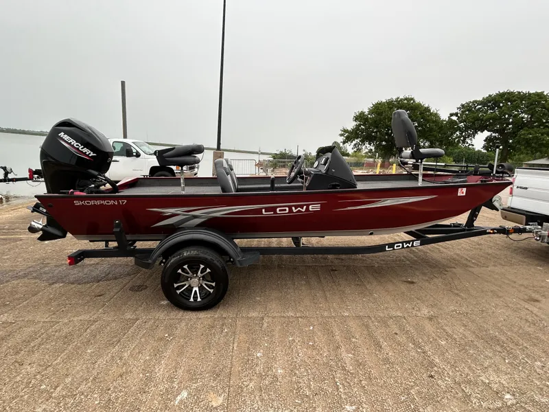 Slide: The Image of 2022 Lowe Skorpion 17 boat on trailer, parked near a waterfront. - 8