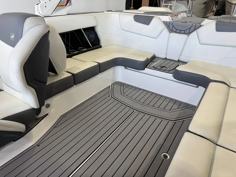 Slide: The Image of 2019 Nautique Super Air Nautique GS22 interior with gray and white seating and flooring. - 13