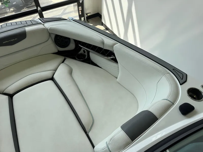 Slide: The Image of 2019 Nautique Super Air Nautique GS22 interior with white leather seating and speaker system. - 16