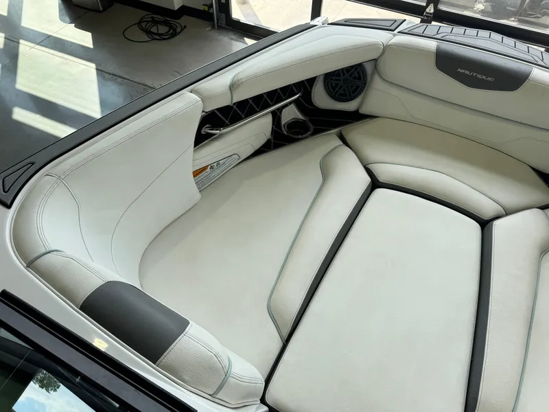 Slide: The Image of 2019 Nautique Super Air Nautique GS22 interior with white leather seating and speaker system. - 17