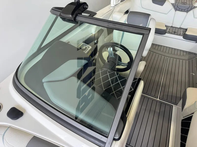 Slide: The Image of 2019 Nautique Super Air Nautique GS22 interior with steering wheel and seating. - 18