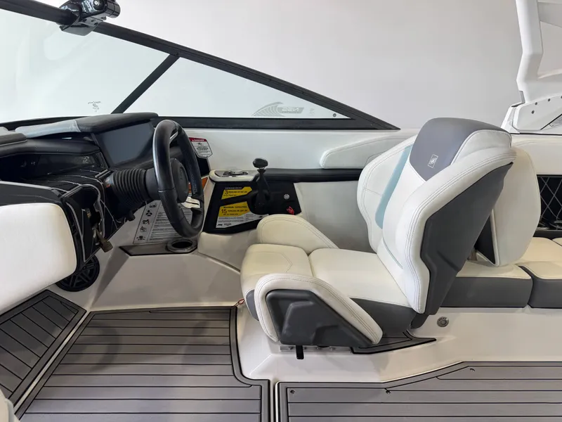 Slide: The Image of 2019 Nautique Super Air Nautique GS22 interior with steering wheel and seating. - 21