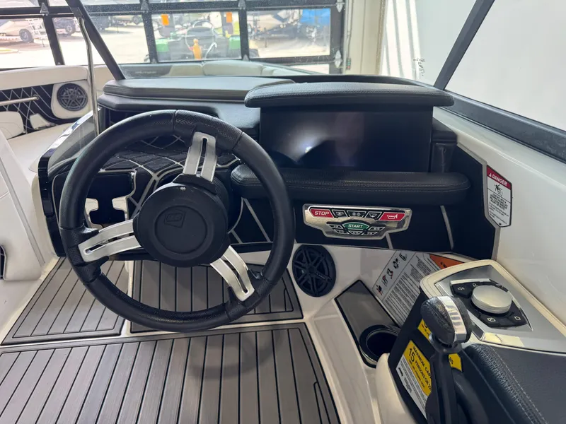Slide: The Image of 2019 Nautique Super Air Nautique GS22 dashboard with steering wheel and control panel. - 24