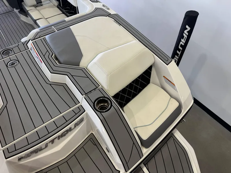 Slide: The Image of 2019 Nautique Super Air Nautique GS22 boat interior with cushioned seating and sleek design. - 9