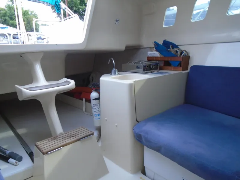 Slide: The Image of Interior of a 1996 Hunter 23.5 sailboat with seating and kitchenette. - 4