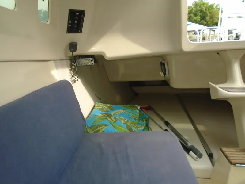 Slide: The Image of Interior of a 1996 Hunter 23.5 sailboat with blue seating and nautical equipment. - 5