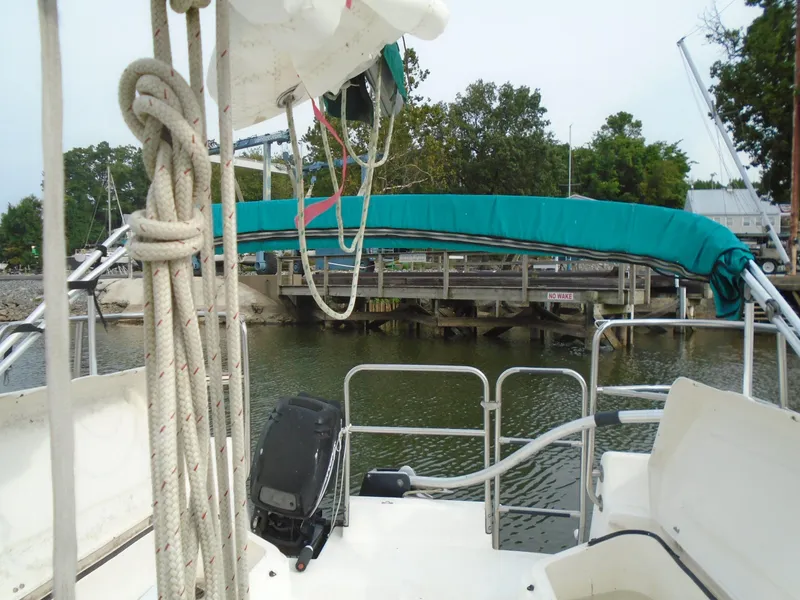 Slide: The Image of Sailboat cockpit view, Hunter 23.5, 1996 model, docked near a wooden pier. - 6
