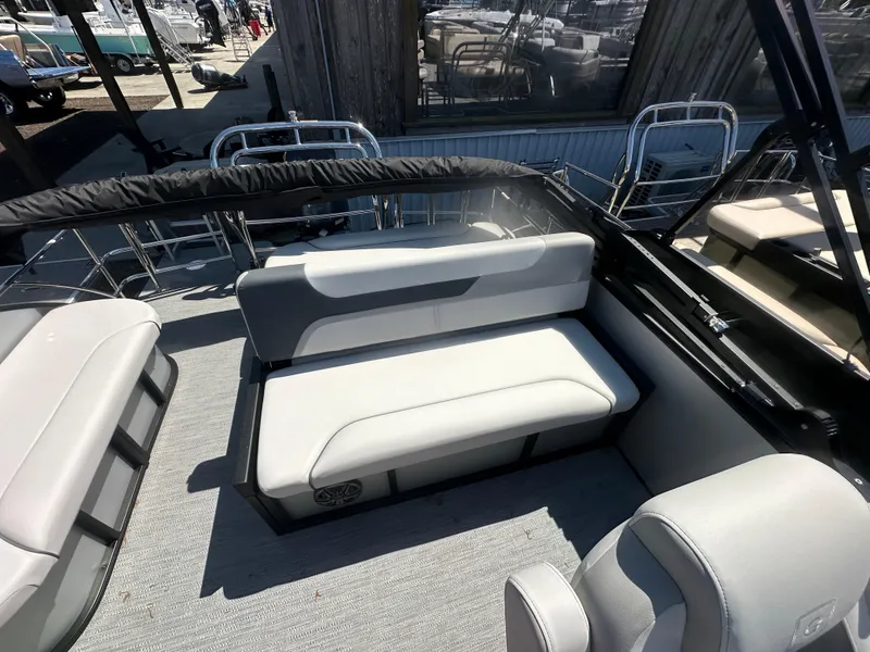 Slide: The Image of 2025 Godfrey Sweetwater 2286 SFLC boat interior with cushioned seating and sleek design. - 11