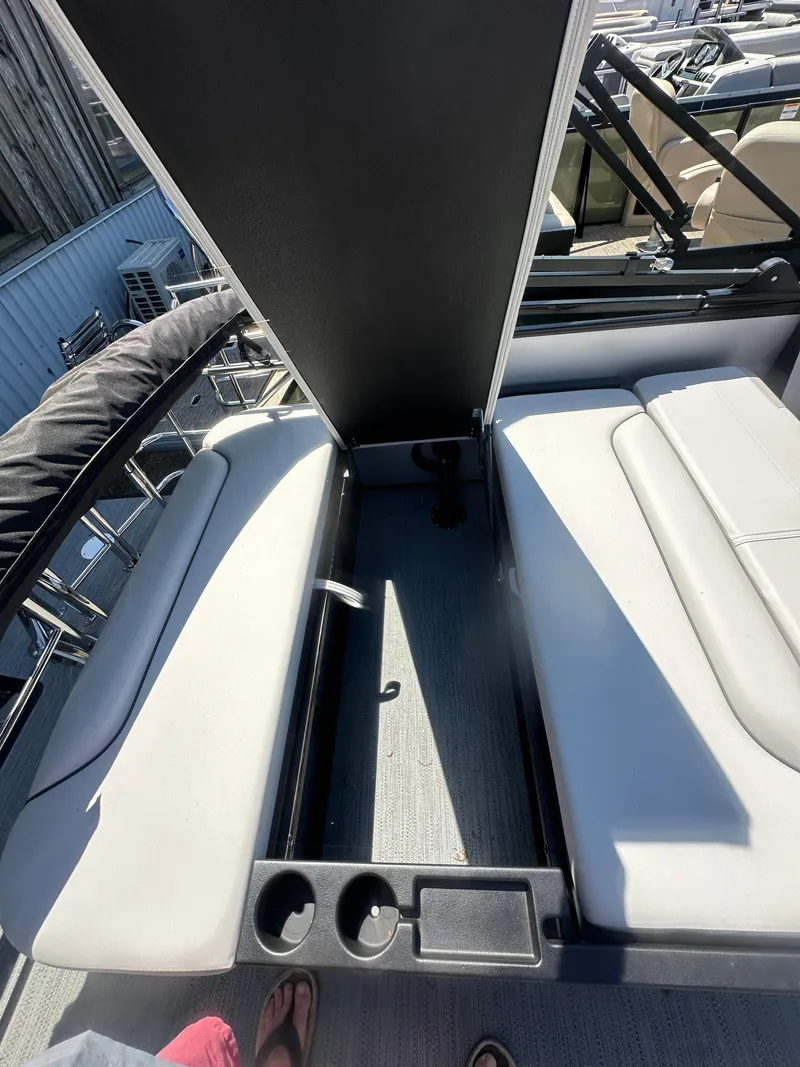 Slide: The Image of 2025 Godfrey Sweetwater 2286 SFLC boat interior with seating and storage compartment. - 13