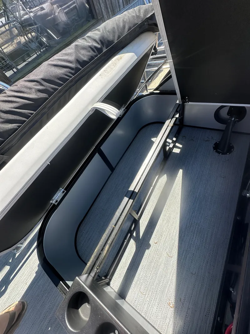 Slide: The Image of 2025 Godfrey Sweetwater 2286 SFLC boat interior storage compartment with open lid. - 14
