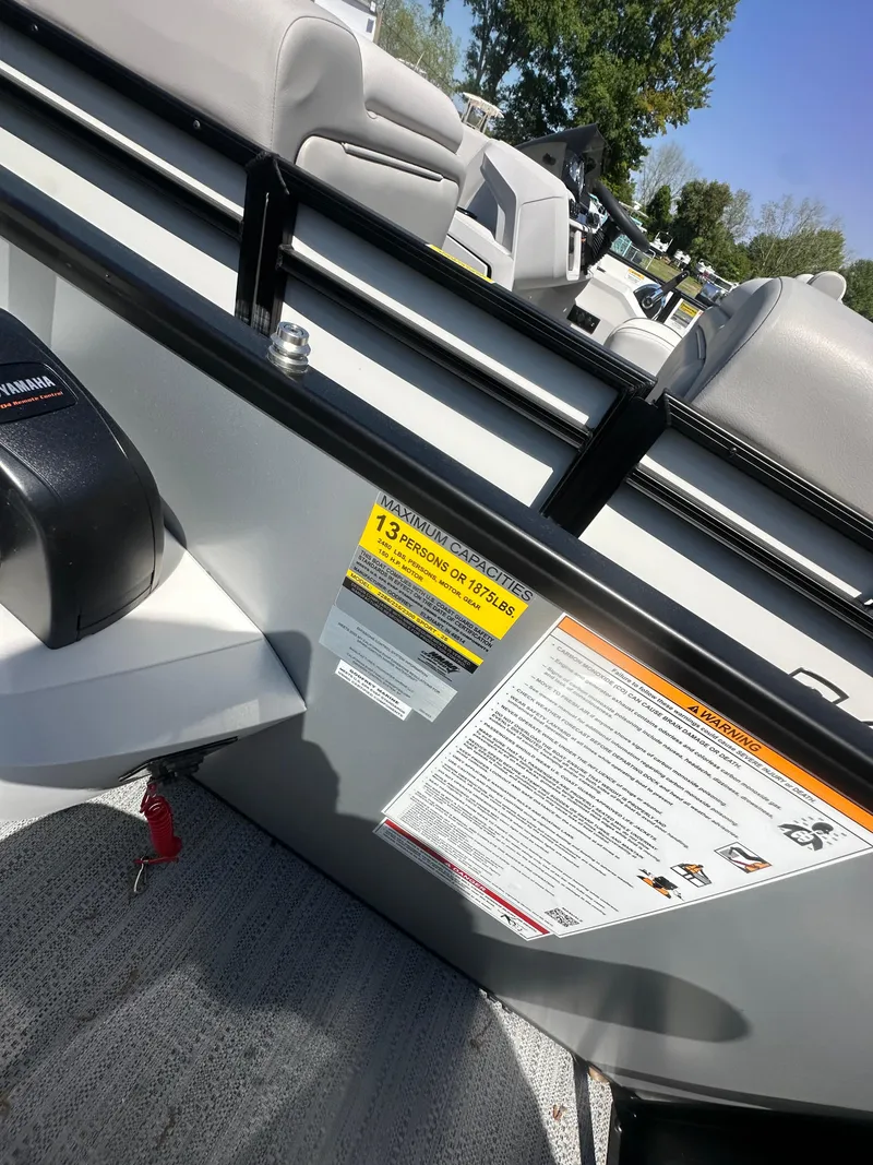 Slide: The Image of 2025 Godfrey Sweetwater 2286 SFLC boat interior with seating and safety labels. - 16