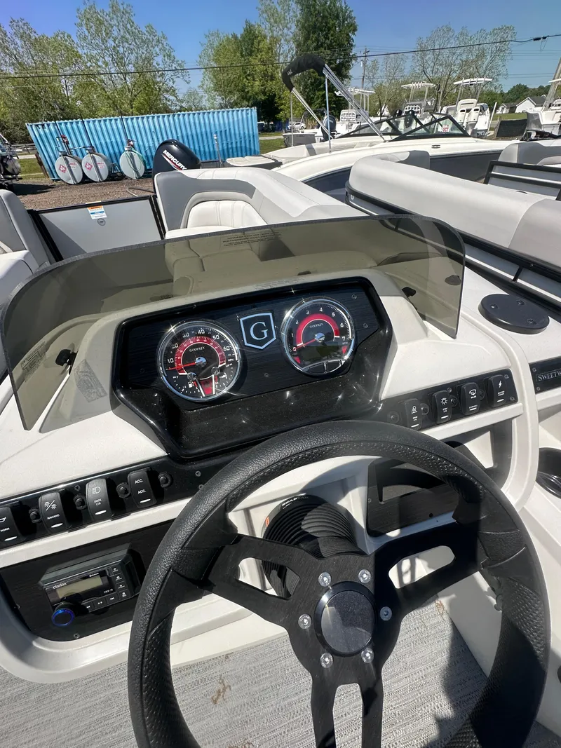 Slide: The Image of Dashboard of 2025 Godfrey Sweetwater 2286 SFLC boat with steering wheel and gauges. - 18