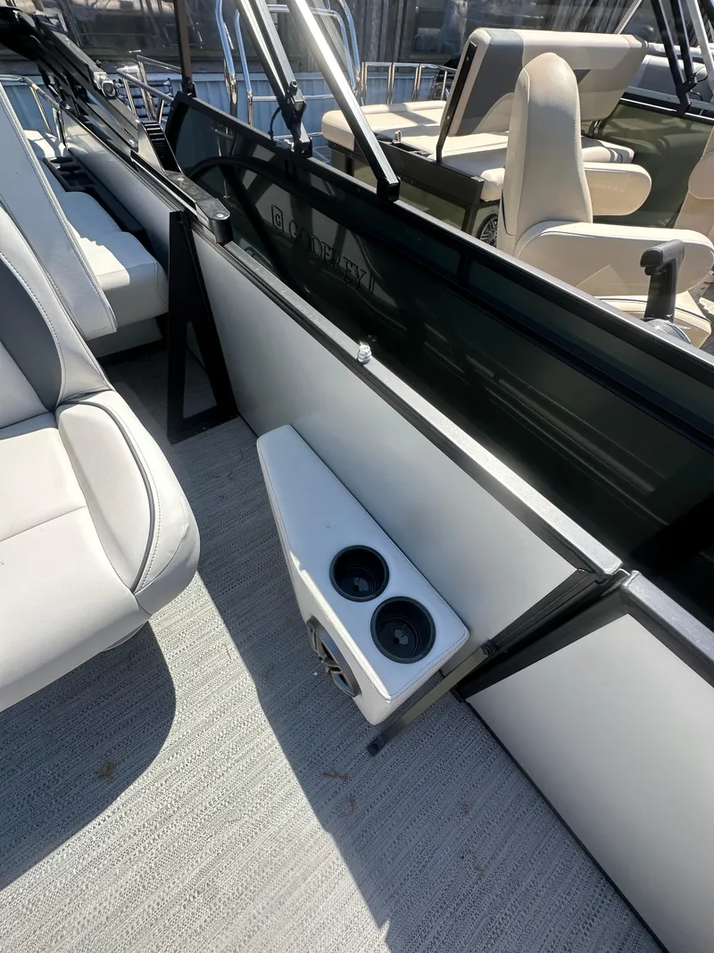 Slide: The Image of 2025 Godfrey Sweetwater 2286 SFLC boat interior with cup holders and seating. - 21