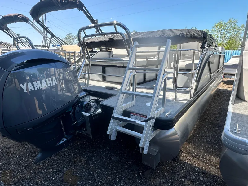 Slide: The Image of 2025 Godfrey Sweetwater 2286 SFLC pontoon boat with Yamaha engine, docked outdoors. - 4