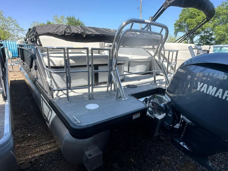 Slide: The Image of 2025 Godfrey Sweetwater 2286 SFLC pontoon boat with Yamaha engine, docked outdoors. - 5