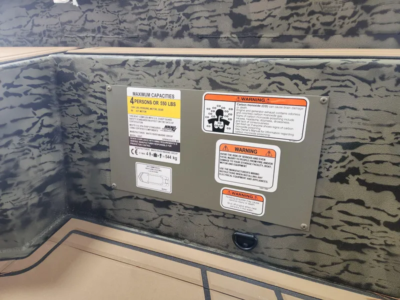 Slide: The Image of 2025 Tracker Grizzly 1650 T Prairie Wings Edition safety and capacity warning labels. - 12