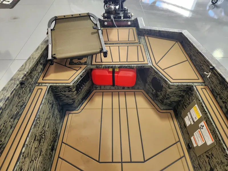 Slide: The Image of 2025 Tracker Grizzly 1650 T Prairie Wings Edition boat interior with camouflage design and seating. - 8