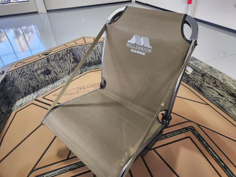 Slide: The Image of 2025 Tracker Grizzly 1650 T Prairie Wings Edition boat seat, camo design, in showroom. - 9