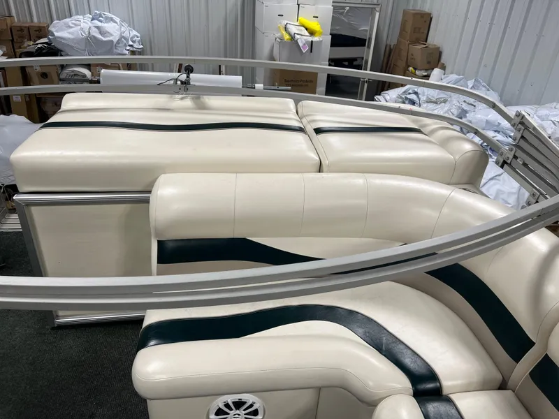 Slide: The Image of 2008 Sweetwater 2386 RE boat interior with white and green seating in storage. - 13