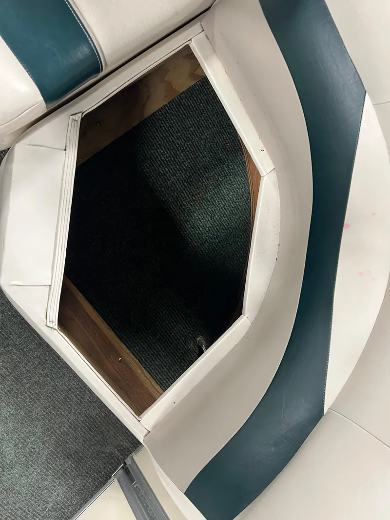 Slide: The Image of Open storage compartment on 2008 Sweetwater 2386 RE boat with green and white seating. - 18