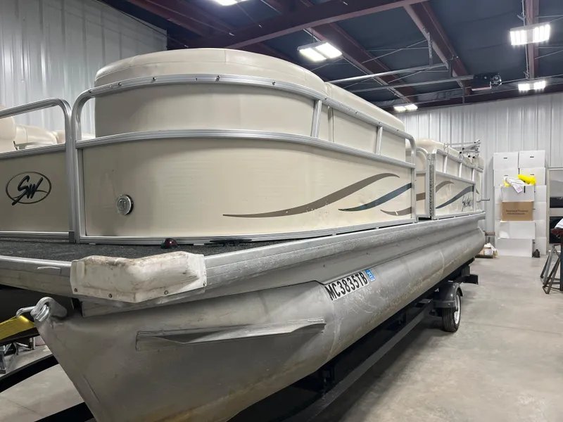 Slide: The Image of 2008 Sweetwater 2386 RE pontoon boat in a warehouse setting. - 2