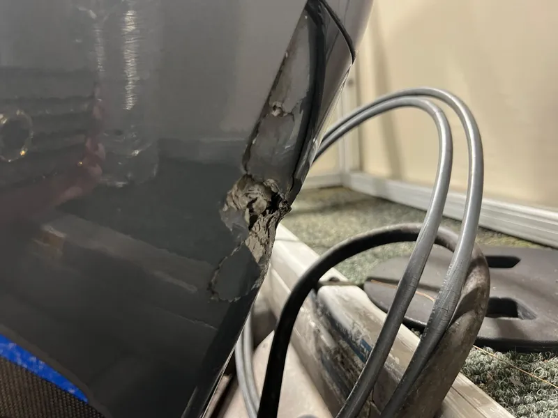 Slide: The Image of Damaged hull of 2008 Sweetwater 2386 RE boat with visible cracks and cables. - 21