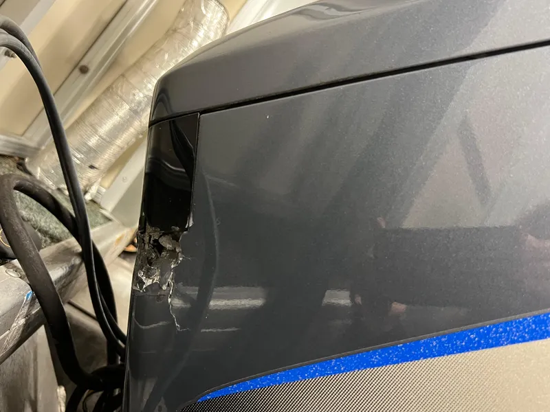 Slide: The Image of Damaged Sweetwater 2386 RE boat panel, 2008 model, with visible cracks and cables. - 22