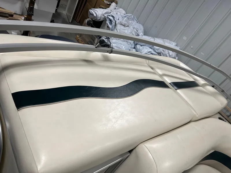 Slide: The Image of White and black seating on 2008 Sweetwater 2386 RE boat, stored indoors. - 5