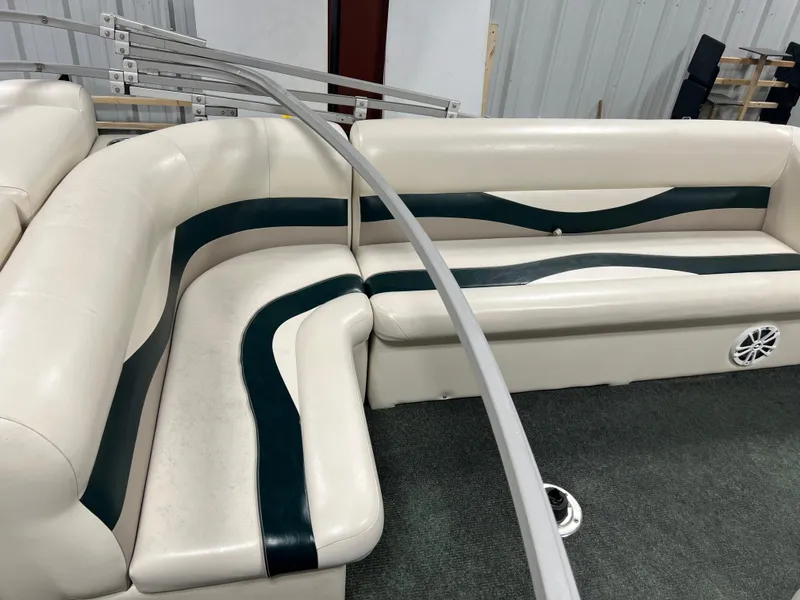 Slide: The Image of Interior seating of a 2008 Sweetwater 2386 RE pontoon boat with white and green upholstery. - 6