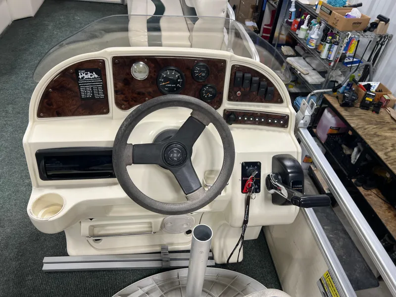 Slide: The Image of 2008 Sweetwater 2386 RE boat dashboard with steering wheel and control panel. - 7