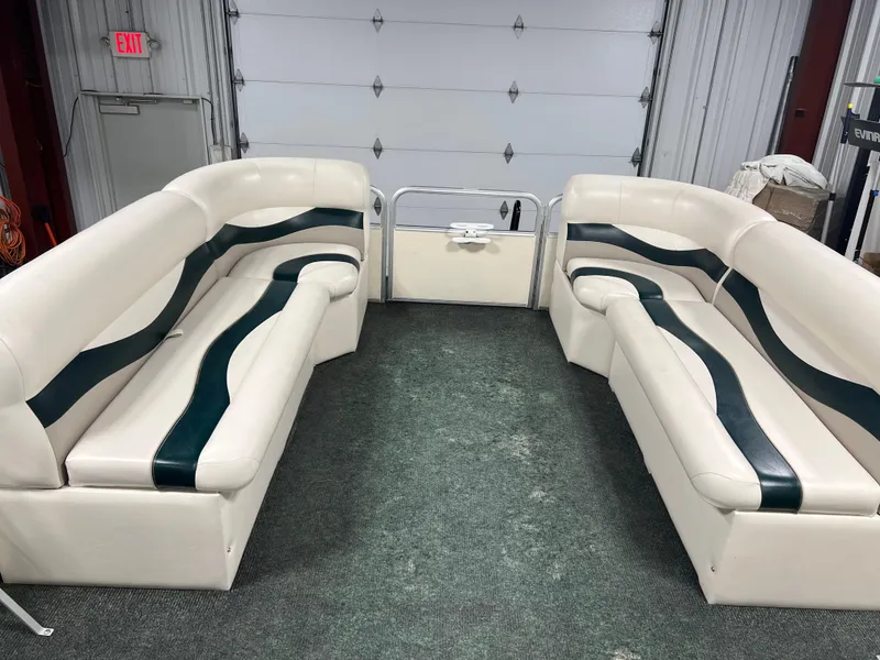 Slide: The Image of Interior of a 2008 Sweetwater 2386 RE pontoon boat with white and green seating. - 8
