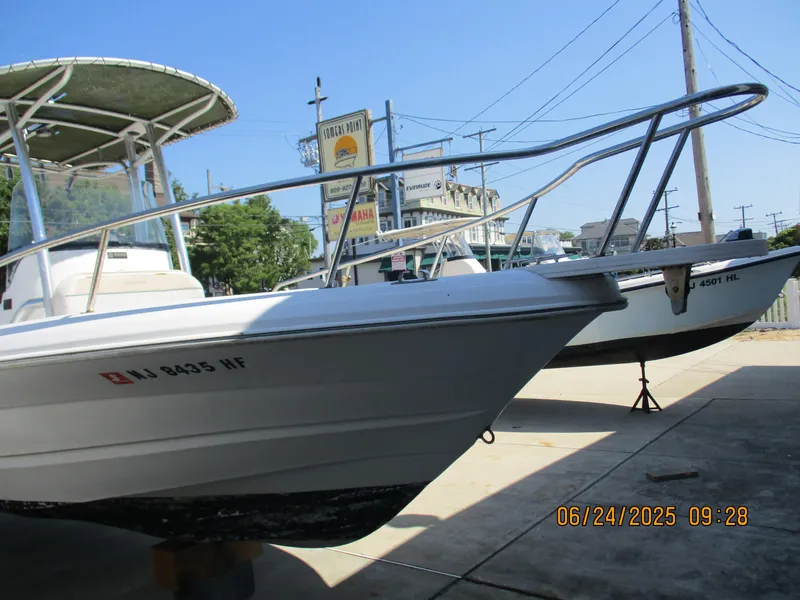 Slide: The Image of 2007 Triumph 21 Center Console boat on display in a marina setting. - 12